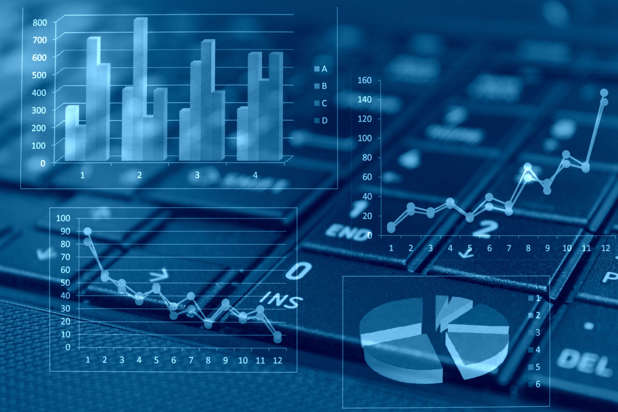 Overlay of multiple digital charts and graphs, including bar graphs, line graphs, and a pie chart, displayed above a close-up of a computer keyboard. The visual conveys data analysis, statistics, or digital business reporting.