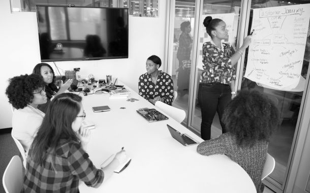 Woman presenting to colleagues 