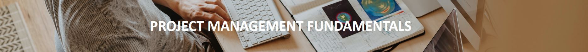 Banner image displaying the text “Project Management Fundamentals” in bold white letters. The background shows a person working at a desk with a wireless keyboard and an open notebook containing handwritten notes and colorful diagrams, evoking a focused and professional atmosphere.