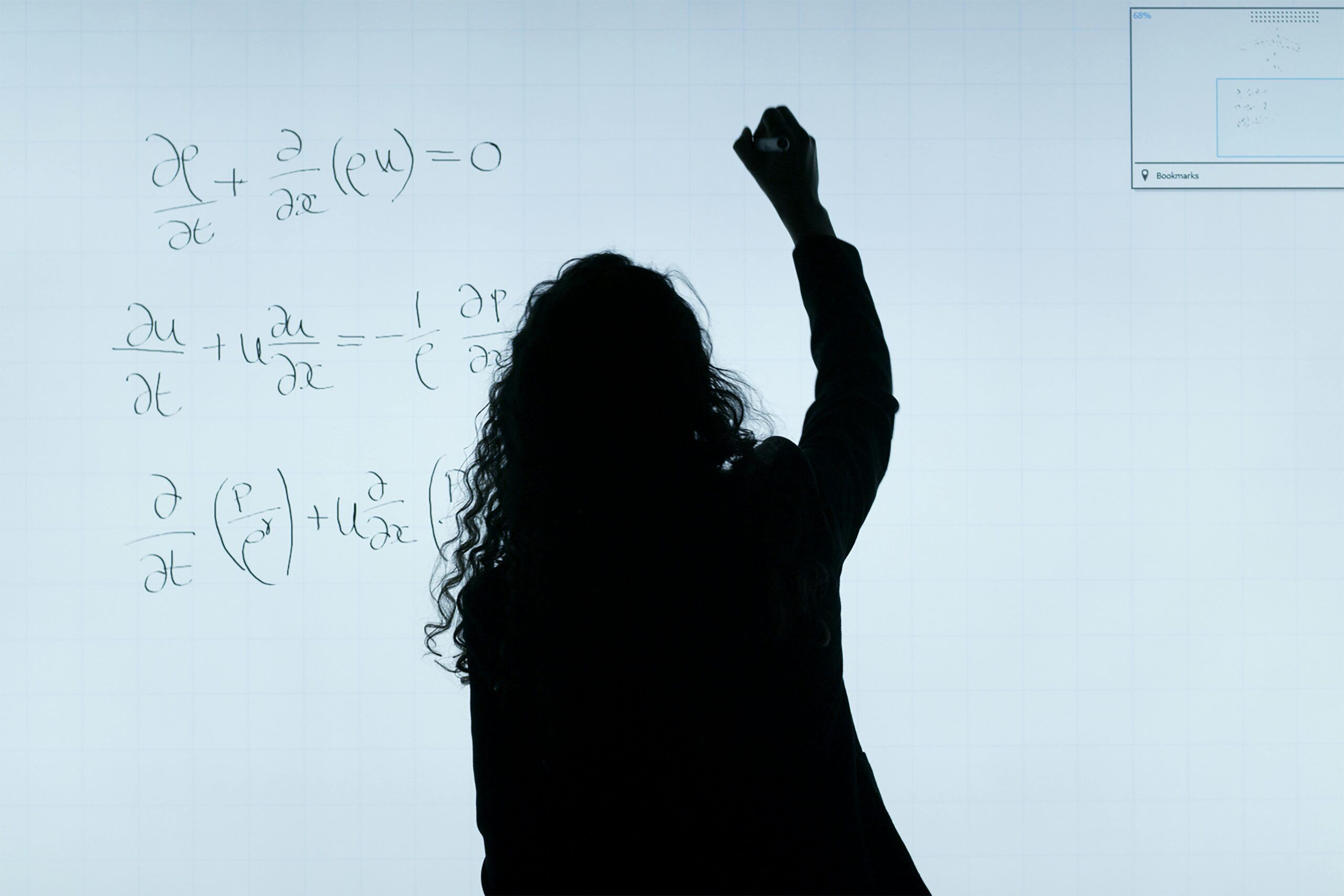silhouette of person writing on a whiteboard