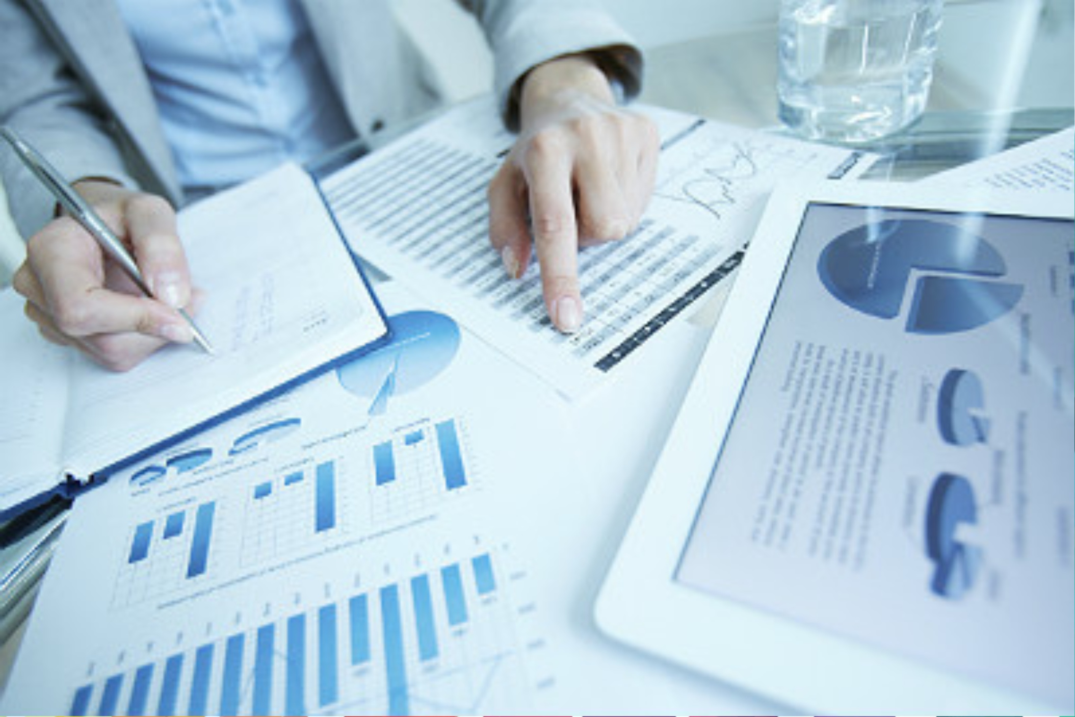 person pointing to numbers in a spreadsheet