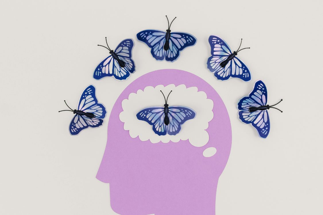 head with butterflies surrounding
