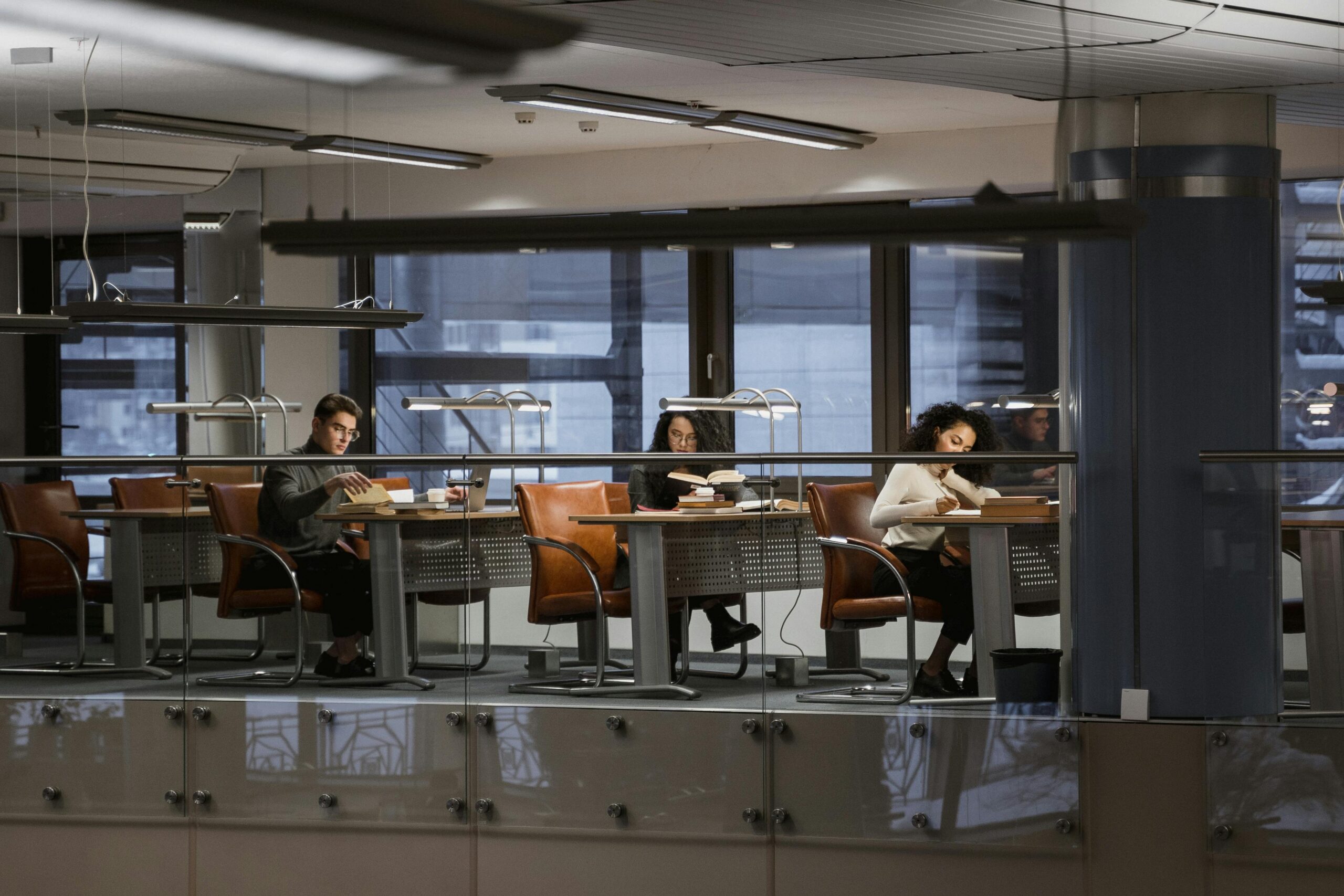 students working in a library with dim lights