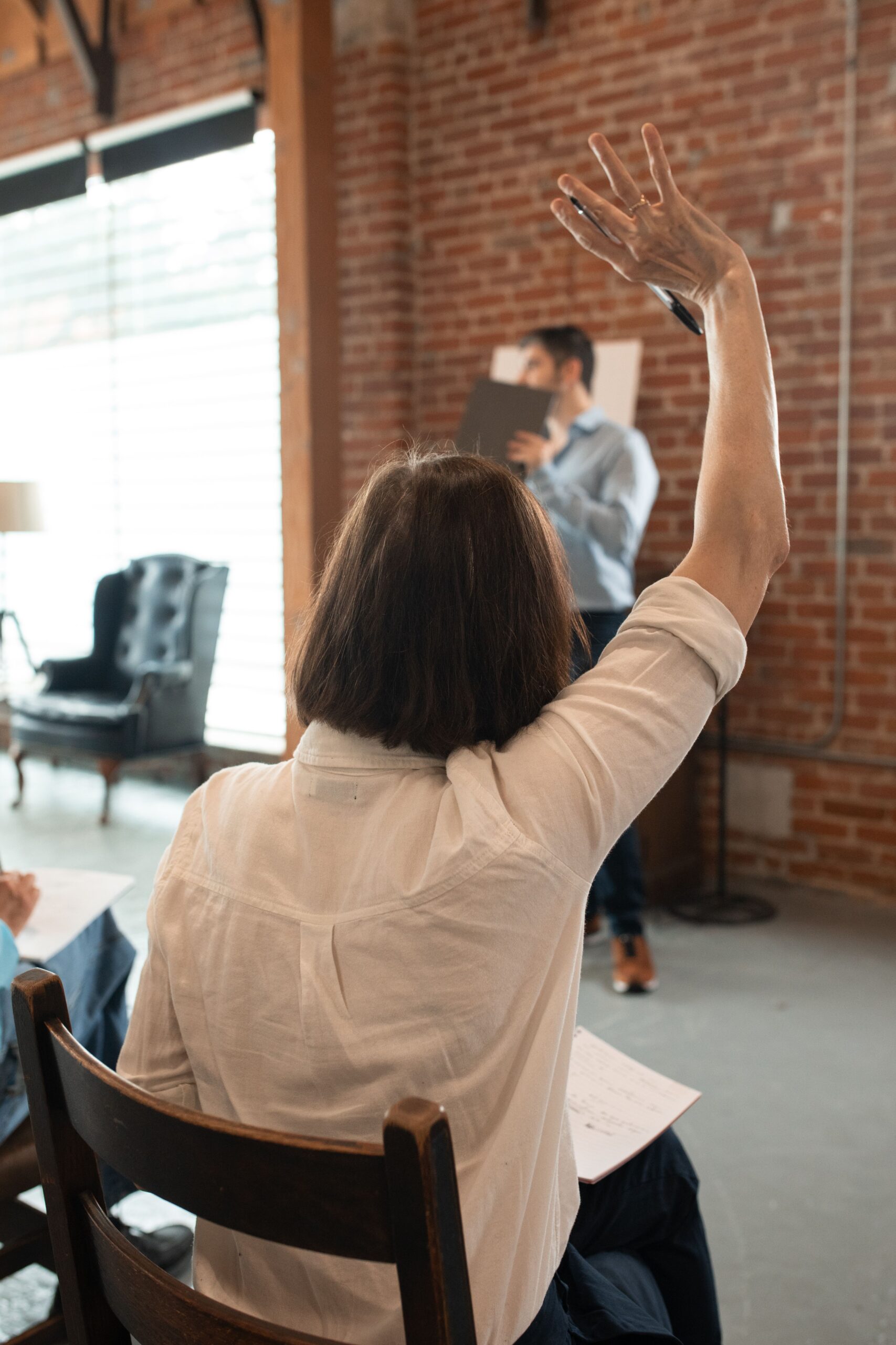 woman raising her hand