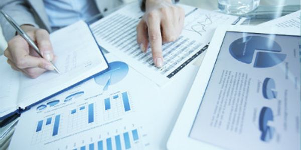 person pointing to numbers in a spreadsheet